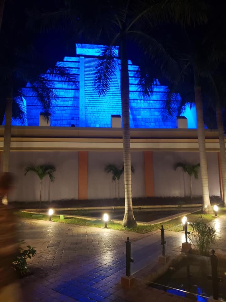 picture of a pyramid lit up in blue at night