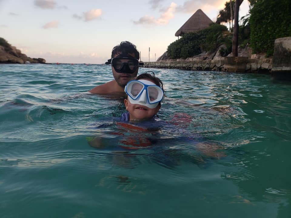 picture of a child and a man with snorkeling masks on