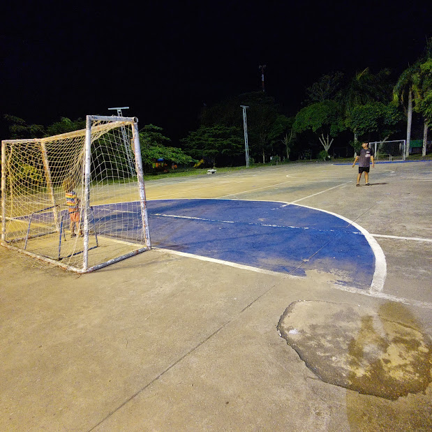 Roby (goal-keeper) playing soccer with some teenagers