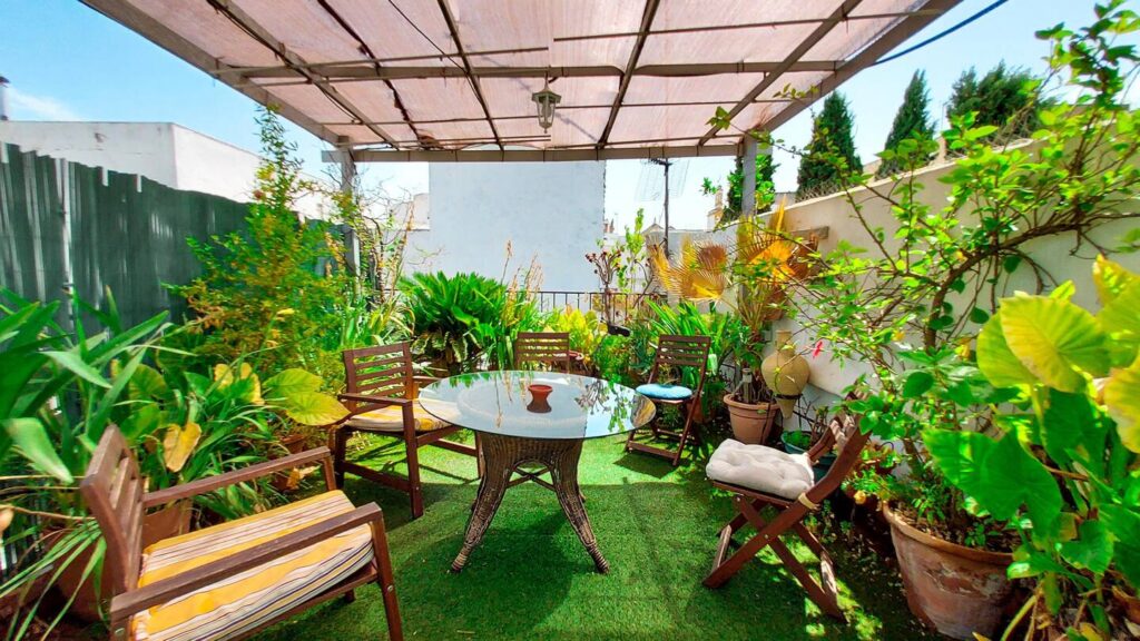 picture of a lush patio with table and chairs
