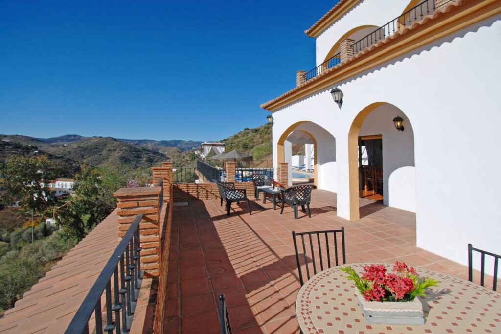 picture of a balcony with two tables