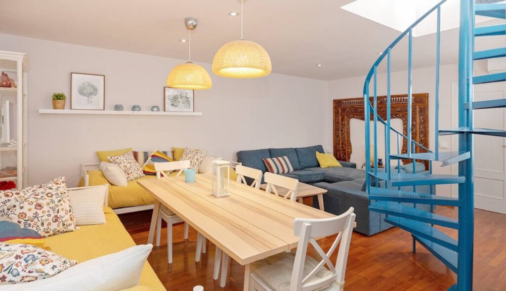 picture of a dining room with a spiral staircase