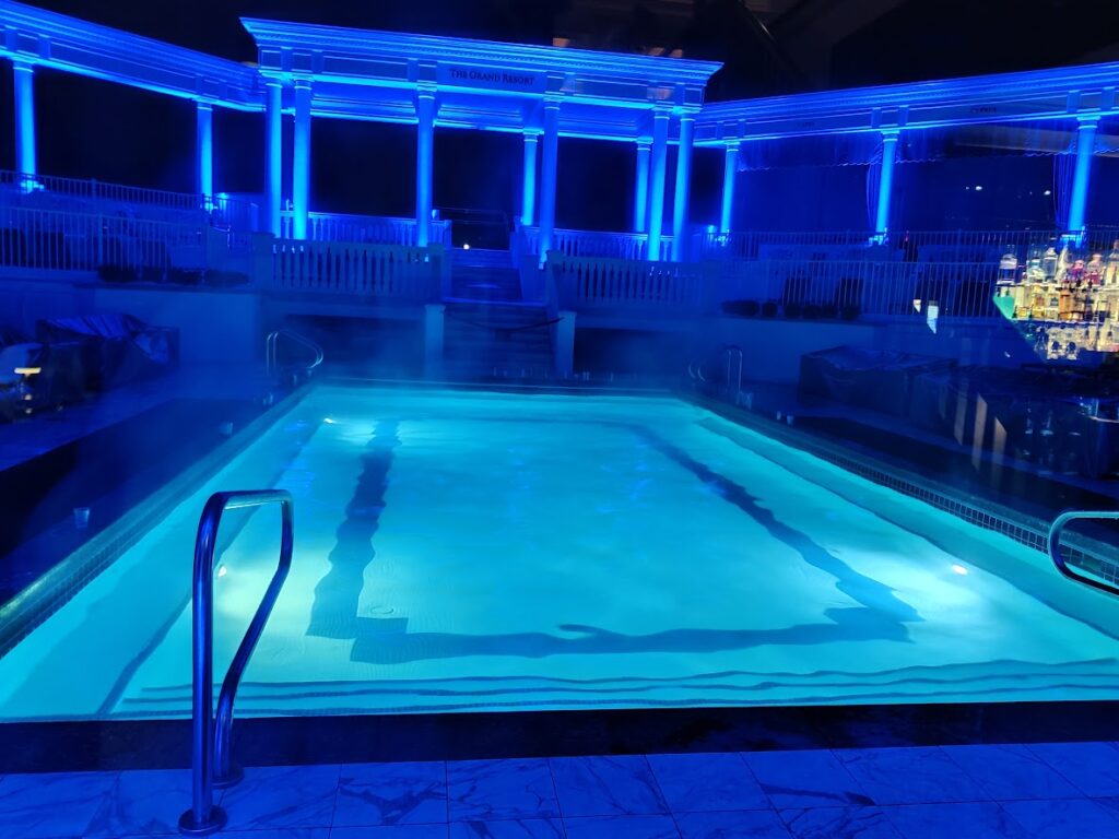 picture of a pool at night, lit up by blue light