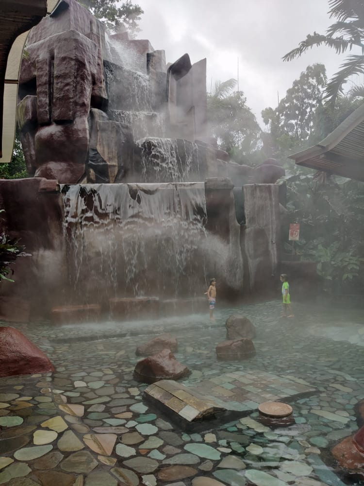 Picture of two children and a man-made waterfall