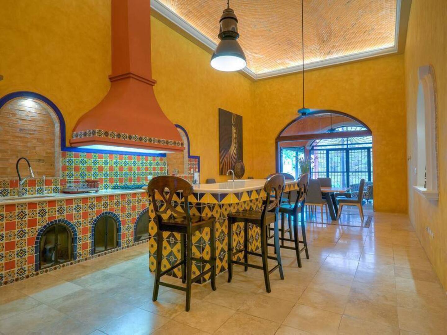 Picture of a yellow kitchen, with Mexican tile work