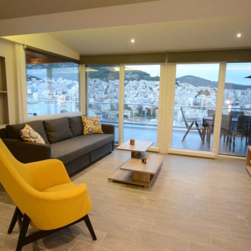 picture of a living room with a couch and a yellow armchair